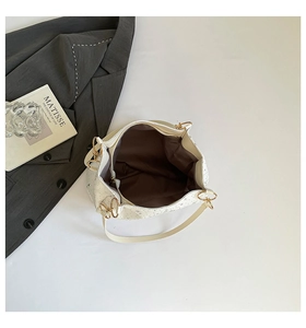 Top view of cream tote bag with star pattern, dark lining and gold metal rings