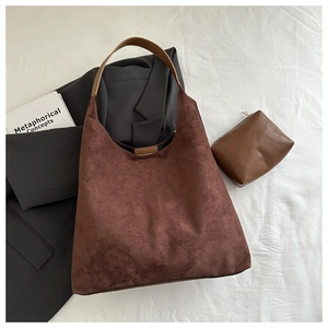 Detail of matte suede tote bag in brown with contrasting strap and small inner pouch