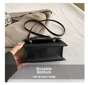 Detailed macro view of the wear-resistant bottom on this black minimalist leather crossbody bag