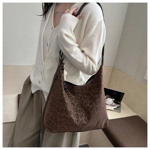 Chic leopard print hobo bag with woven charm detail styled with casual autumn outfit