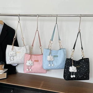 Star pattern tote bags in white, pink, blue, and black with gold chains and cloud charms