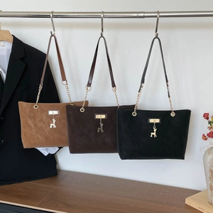 Three minimalist matte faux suede tote bags with deer charms in neutral colors