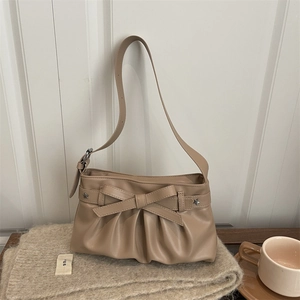 Beige tote bag with bow knot, star studs and cloud pleats on cozy knit background