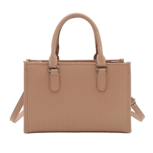 Minimalist beige leather tote bag with vertical striped texture and adjustable strap