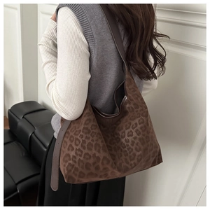 Fashionable leopard print shoulder bag worn by model, showing its large capacity style