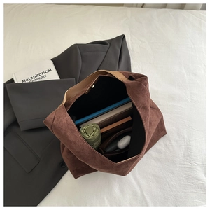 Top-down view of spacious brown suede tote bag showing magnetic closure and interior storage