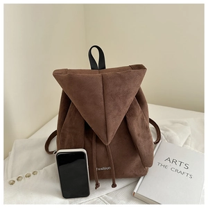 Detail of brown faux suede backpack with cute rabbit ears and fashion embroidery