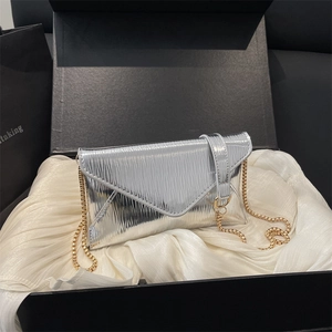 Silver envelope crossbody bag with metallic ripple texture and golden chain strap