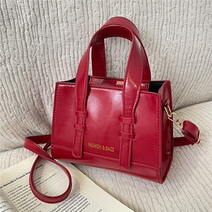 Glossy red large-capacity tote bag with golden handles and detachable shoulder strap