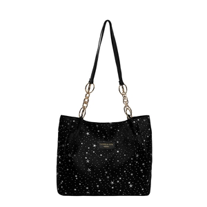 Chic black tote bag with white star pattern and elegant gold chain shoulder straps