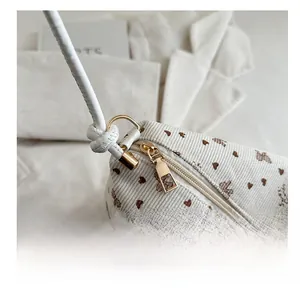 Detail of corduroy texture with heart patterns and premium golden metal zipper puller