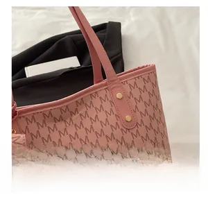 Nahaufnahme der goldenen Nietverstärkung an der rosa Monogramm-Tote-Bag aus PU-Material
