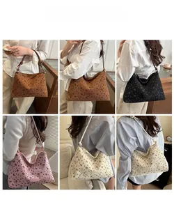 Model showcase of printed tote bags in brown, black, pink, and beige with knot details