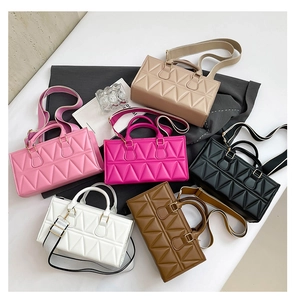 Detailed view of six textured triangle quilted bags in pink, rose, beige, black, white, and brown