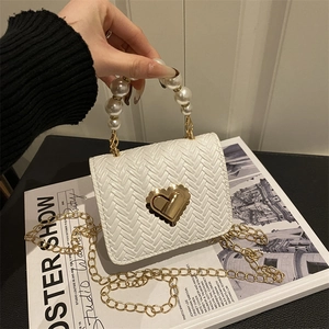 Elegant white woven crossbody bag with pearl handle and golden heart lock