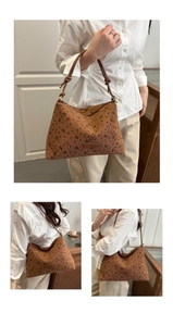 Detail view of brown corduroy tote bag with black heart and butterfly print