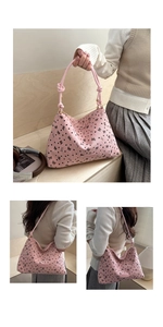 Detail of pink corduroy tote with black bow patterns and knotted rope handle design