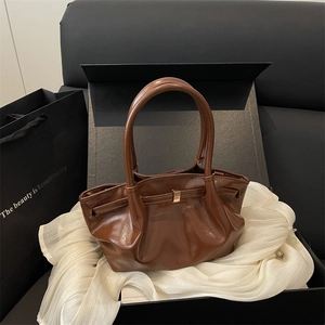 Modern dark brown glossy leather bucket bag with pleated design and gold hardware