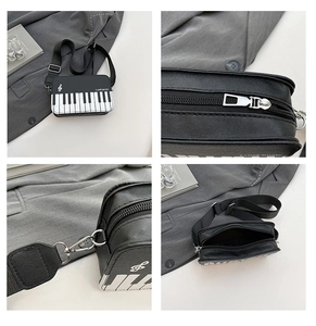 Detail of creative piano shoulder bag featuring musical keys and silver zipper