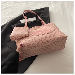 Pink tote bag set with M-pattern print and embossed logo on white bedsheet texture