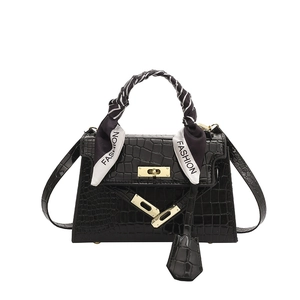 Black crocodile-patterned Kelly style handbag with gold hardware and silk scarf handle