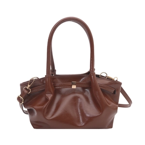 Dark brown high-gloss leather handbag with ruched texture and gold buckle detail