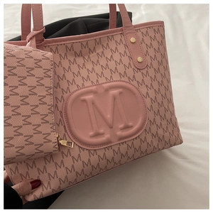 Detailed shot of pink tote bag with letter M pattern and matching zipper pouch