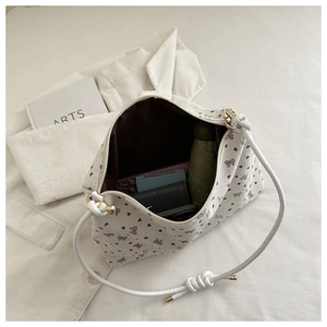 Polka dot bow tote bag interior showing large capacity for umbrella and wallet