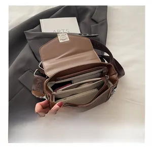 Internal view of brown leather crossbody bag with multiple functional compartments and strap