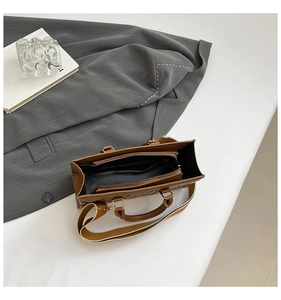 Top view of quilted brown crossbody bag showing internal compartments and wide strap