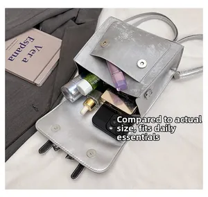 Internal storage detail of silver bow backpack showing makeup and phone capacity