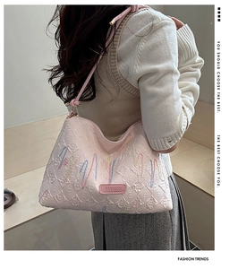 Detail of pink quilted tote bag with colorful wave embroidery and Fashion logo