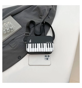 Detail of creative piano cross-body bag featuring keyboard flap and I LOVE MUSIC print
