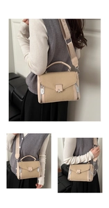 Detail of beige canvas crossbody bag with wide logo strap and metallic push-lock closure