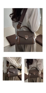 Detailed view of brown PU leather crossbody bag with wide branded logo shoulder strap
