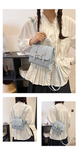 Three-way pale blue backpack with bow clasp shown as handbag, shoulder and crossbody bag