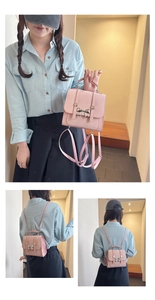 Detailed view of pink mini backpack featuring a silver metal bow buckle and PU leather texture
