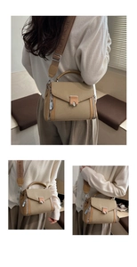 Detail of khaki handbag featuring canvas texture, metal lock and fashion wide strap