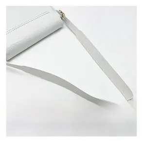 Detailed close-up of white crocodile pattern shoulder strap with sturdy metal hardware