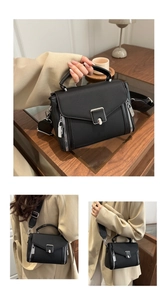 Detail of black minimalist tote bag featuring wide strap and silver metal buckle closure