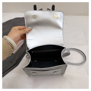 Detail view of silver bow backpack interior with magnetic snap and zipper pocket