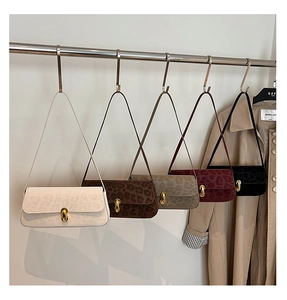Five leopard print baguette bags in various colors with gold metallic twist locks