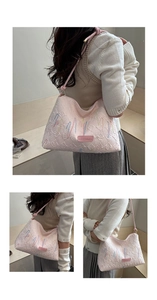 Detail of pink embroidered tote bag featuring textured faux leather and FASHION label