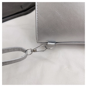 Detail of silver metallic PU bag showing chrome lobster clasp and chain strap