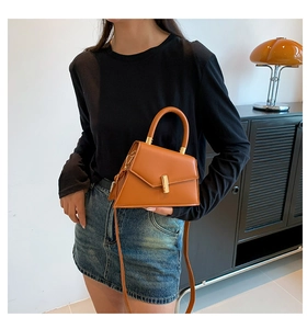 Détail du sac à main orange en cuir PU avec forme trapèze et fermoir doré chic