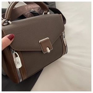 Detail of premium brown canvas and leather bag with silver buckle and fashion strap