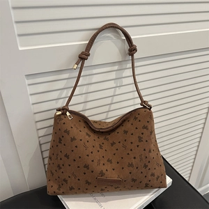Brown corduroy tote bag with black bow and heart patterns, featuring a leather knot strap