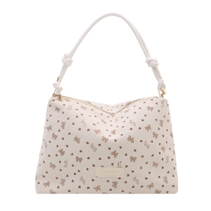 Cream corduroy tote bag with heart and bow patterns and cylindrical knotted handles