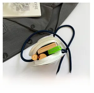Detailed interior view of white petal bag showing space for lipstick and makeup compact