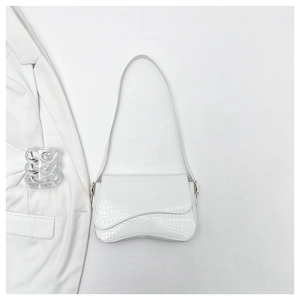Detail of white crocodile pattern shoulder bag with a unique wavy irregular flap design